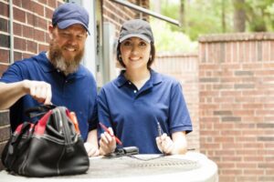 male0and-female-hvac-technicians-outside-with-tool-kit-on-ac-unit