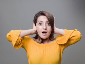 woman-holds-hands-over-ears-to-shut-out-noise